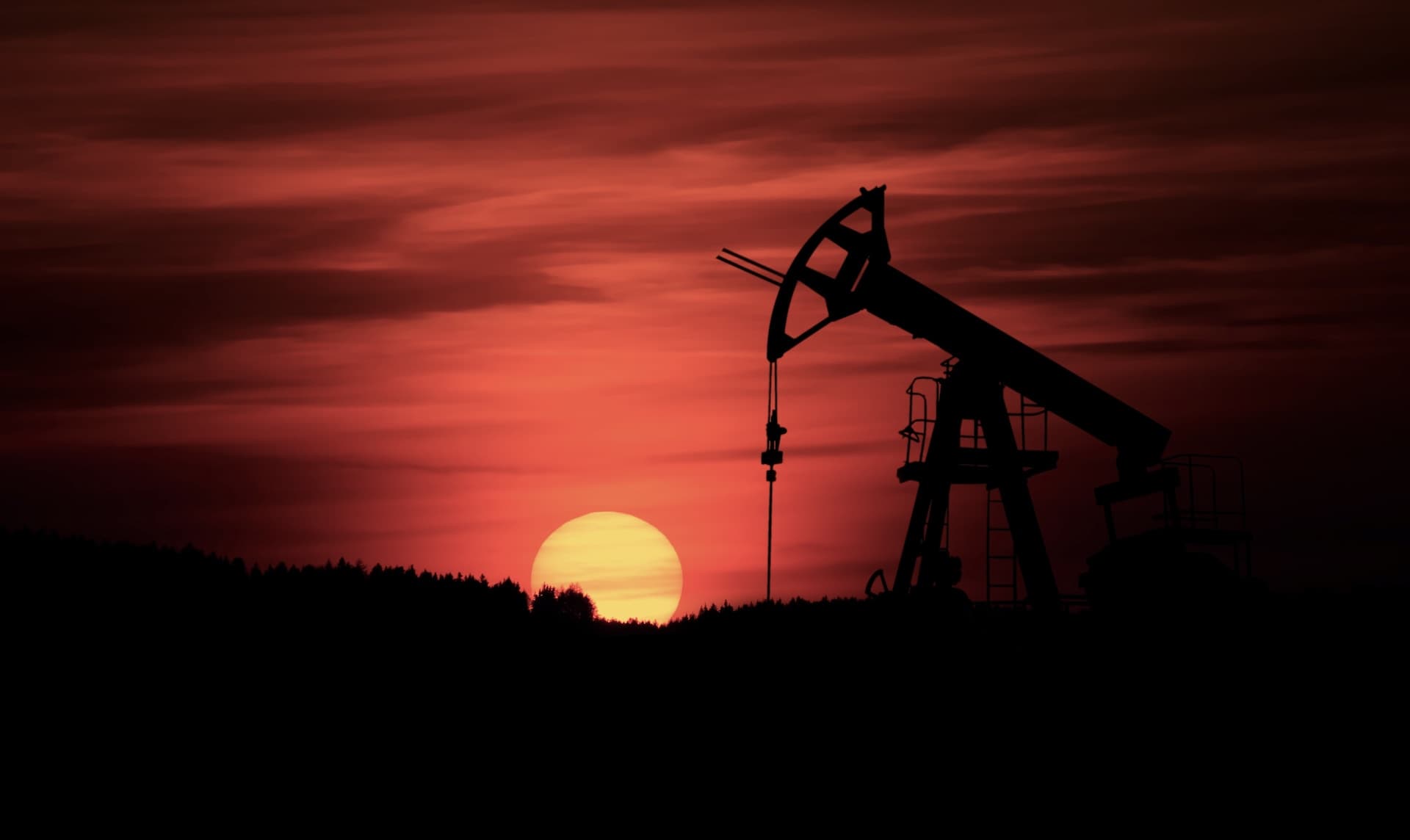 Pump-jack mining crude oil with the sunset by Zbynek Burival